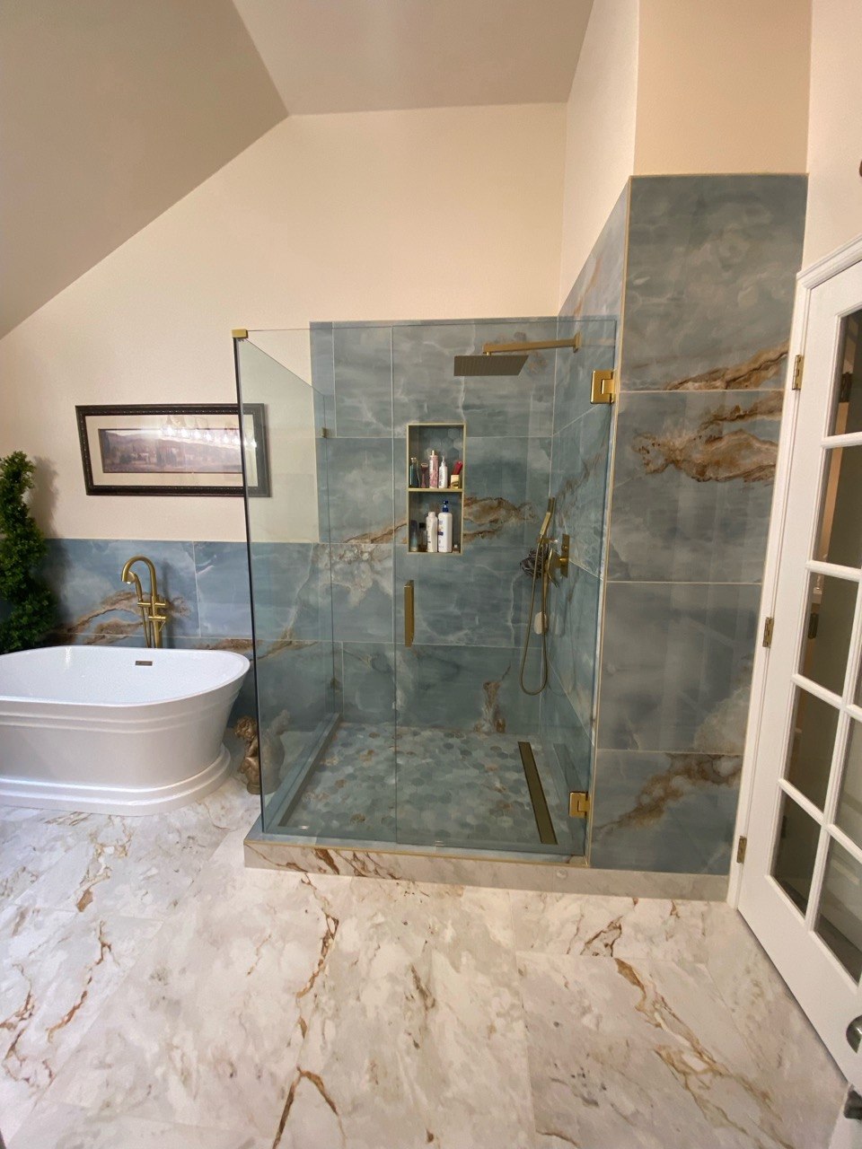 Glass corner shower with blue-grey marble